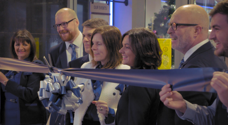 Bank of Scotland staff cutting a ribbon in-branch