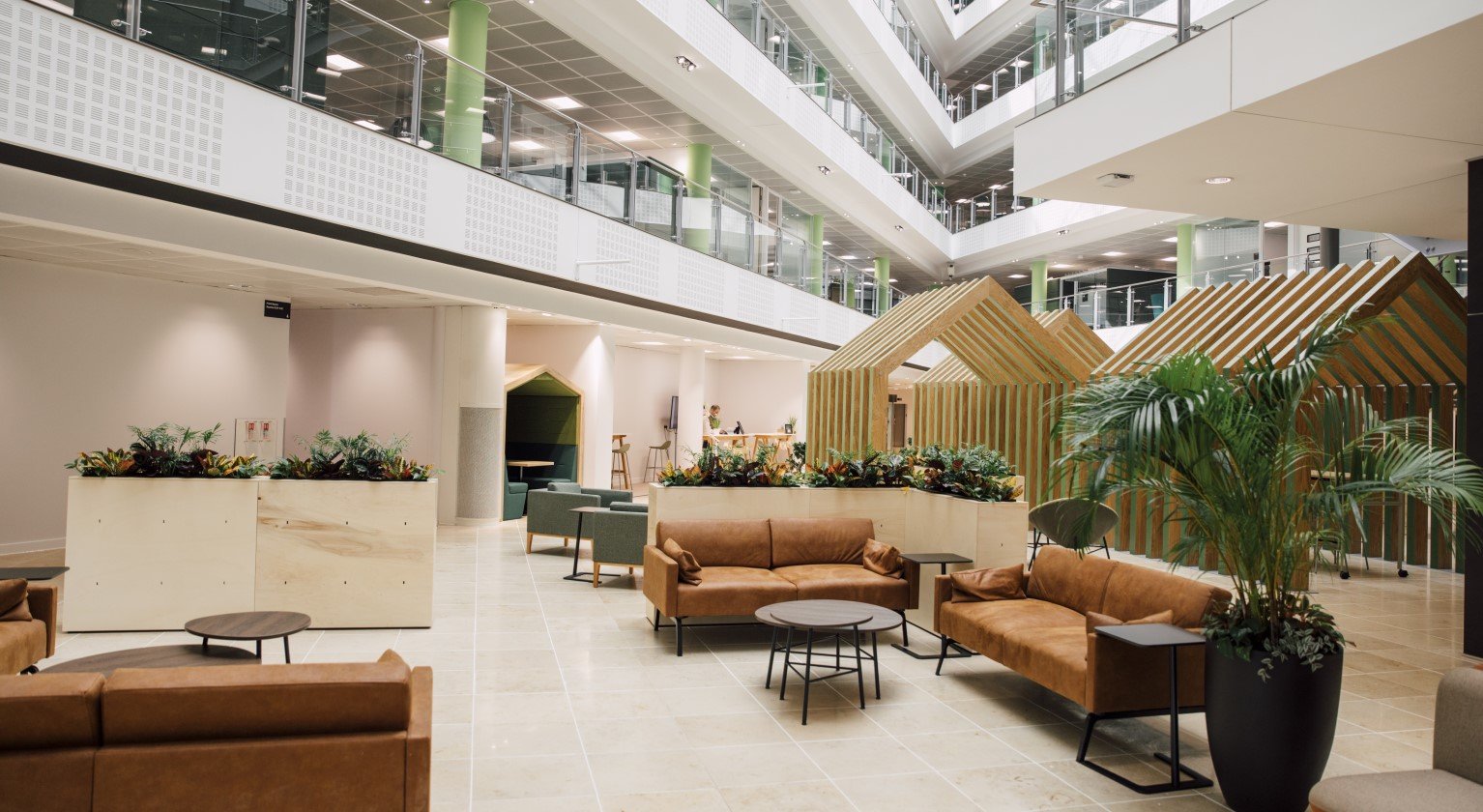 Image of a variety of workspaces including meeting rooms and desks 