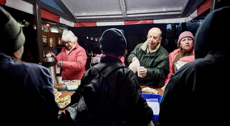 Volunteers handing out hot drinks