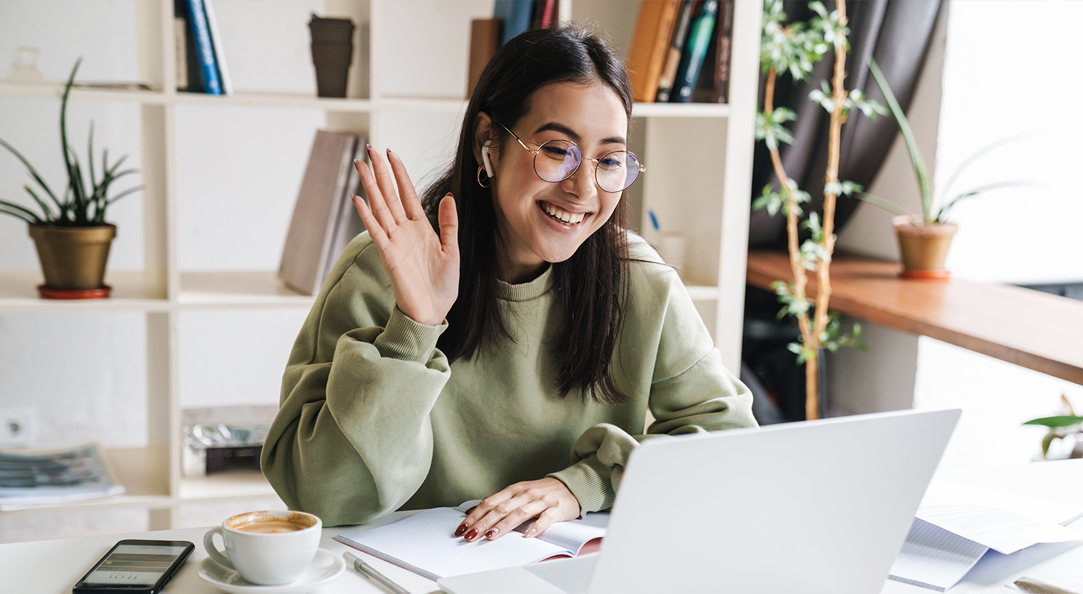 Woman waving on a video call