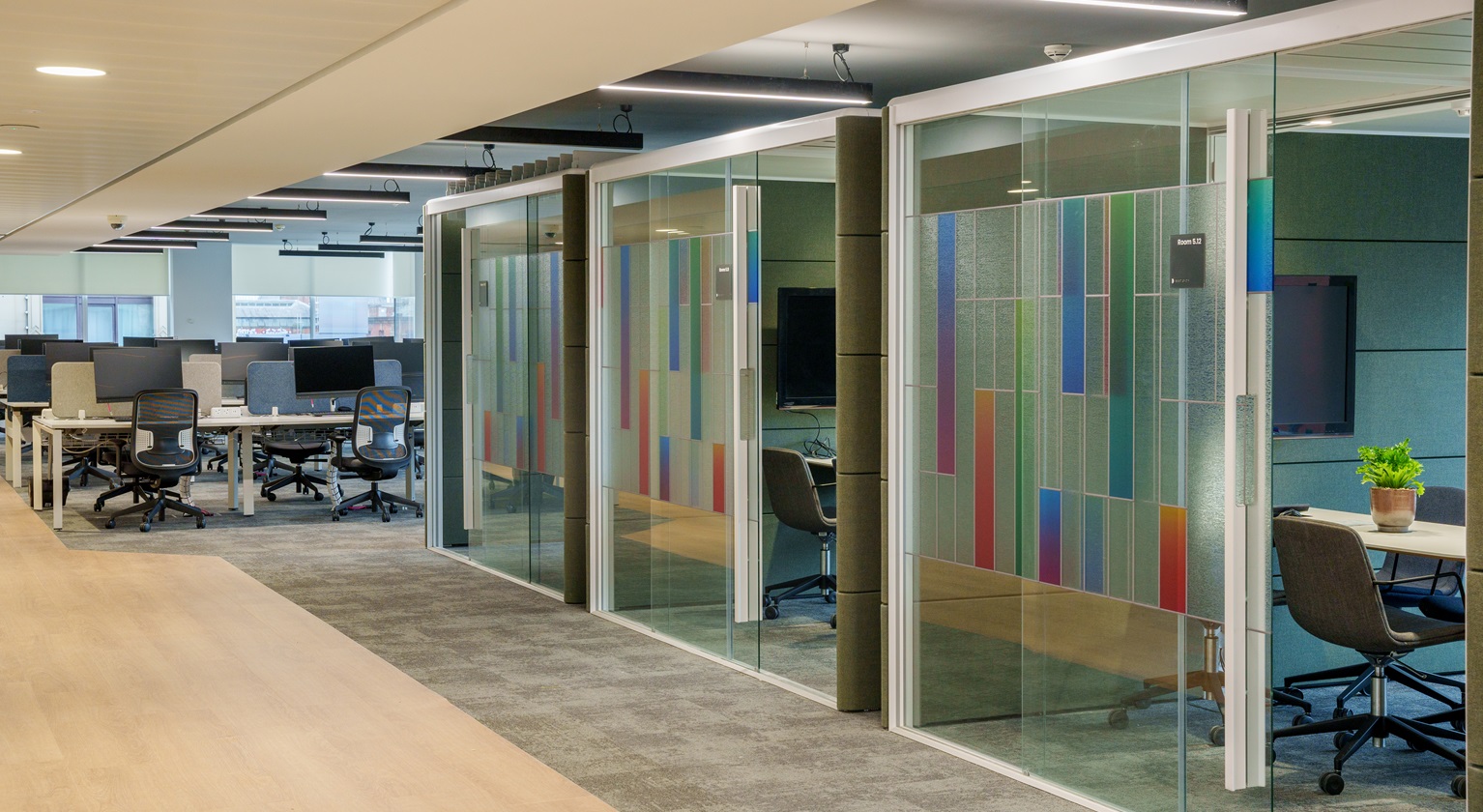 Image of a variety of workspaces including meeting rooms and desks 