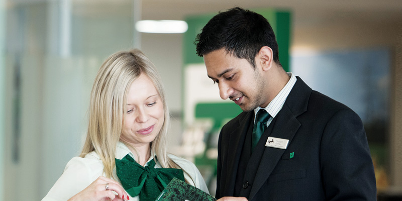 Man and woman Lloyds bank branch employees