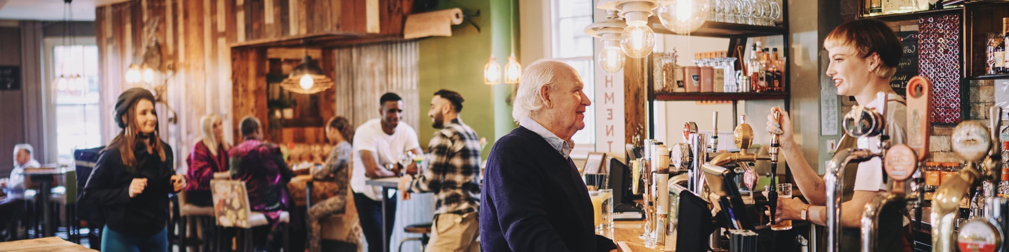 English pub with customer talking to bar staff