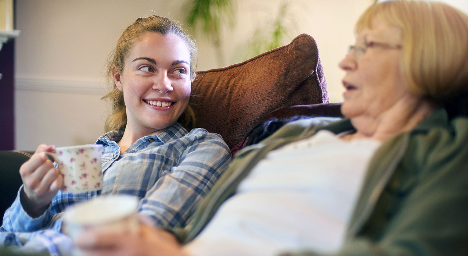 Woman sat on sofa talking to her nan